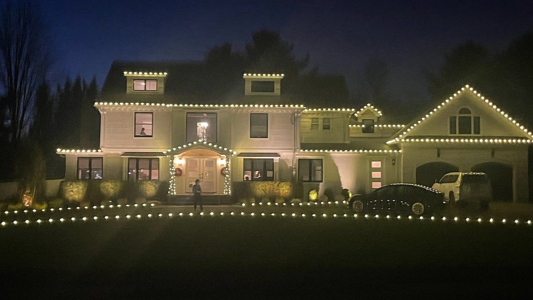 Large modern home holiday lighting NJ ground lights and roofline
